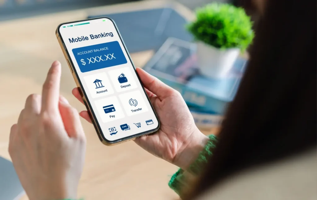 Žena sleduje stav účtu a možnosti správy financí v mobilní bankovní aplikaci