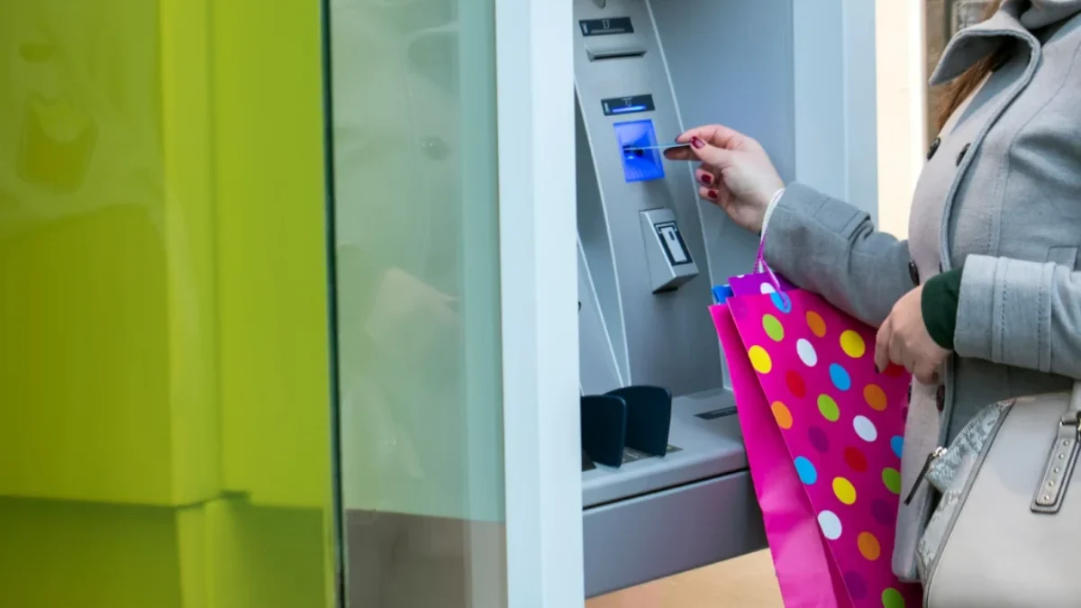 Žena vkládá kartu do bankomatu